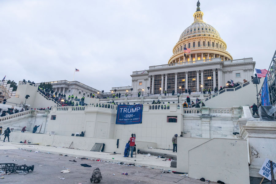 Police confront rioters around Capitol building where pro-Trump supporters riot and breached the Capitol. Washington, DC - January 6, 2021. Editorial credit: Lev Radin / Shutterstock.com, licensed.
