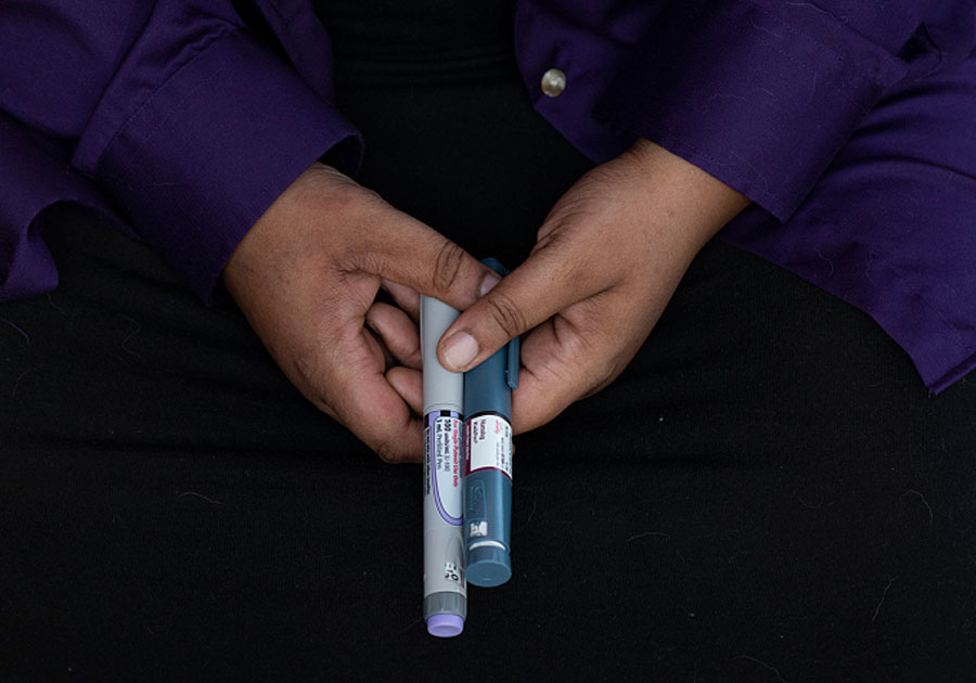 Mattern turned to an underground network to secure insulin for her Type 1 diabetes before recently qualifying for Medicaid. At home in Denver, on Sept. 24, Mattern displays her insulin pens. Photo credit: Rachel Woolf, Kaiser Health News.