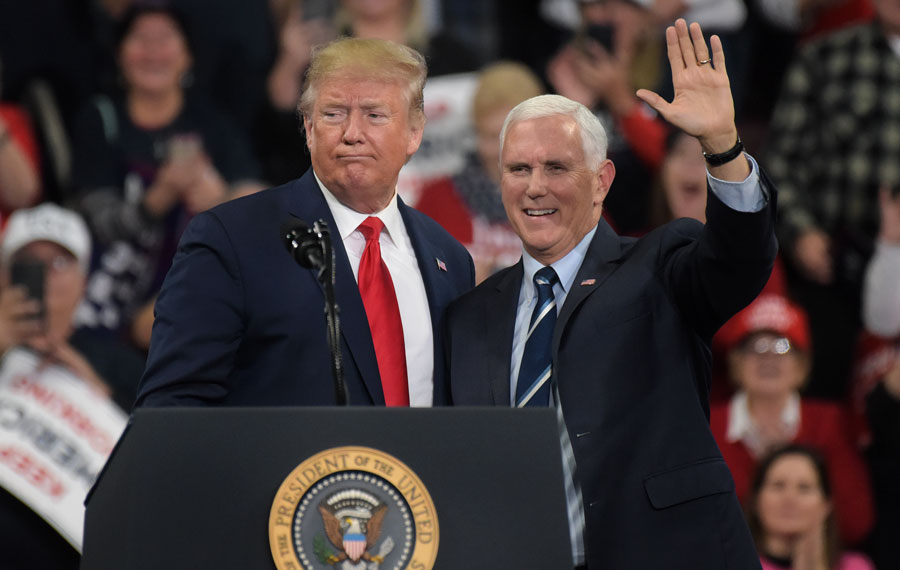 President Donald Trump, left, appears with vice-president Mike Pence, right, during a rally Dec. 10, 2019, at Giant Center in Hershey, Pennsylvania. December 10, 2019, Editorial credit: Matt Smith Photographer / Shutterstock.com, licensed.