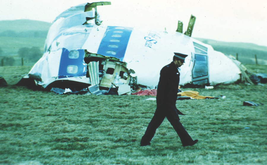 A Scottish police officer surveys wreckage of Pan Am Flight 103 in Lockerbie, Scotland. Photo: Federal Bureau of Investigation / AP.