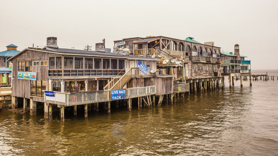 Waterfront buildings on stilts in the historic downtown Cedar Key which holds a spot on the National Register of Historic Places since 1989. Cedar Key, Florida on January 15, 2015. Editorial credit: Nick Fox / Shutterstock.com, licensed.