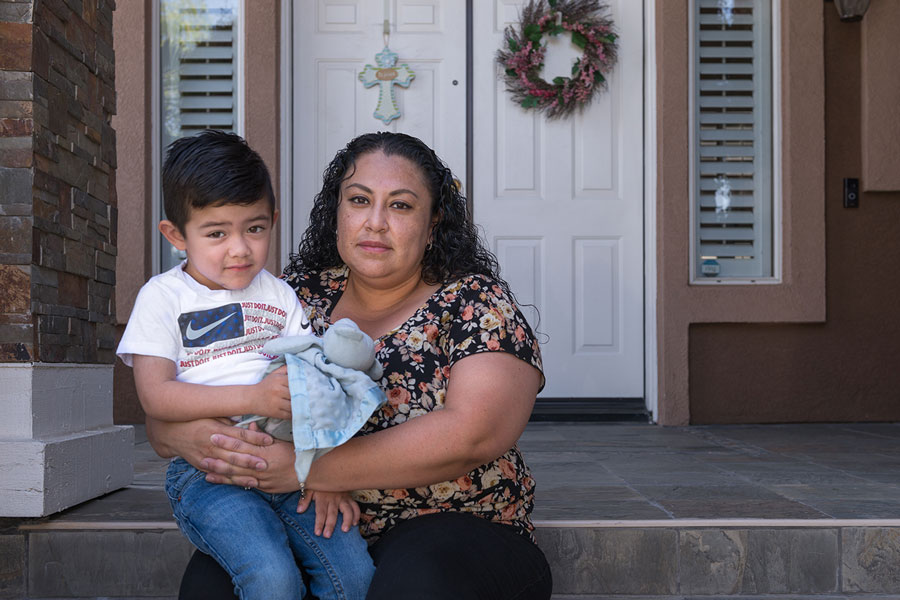 Nancy holds her son, 3-year-old Ezekiel. A licensed vocational nurse, she stopped working after he was born. Her husband was the main breadwinner, and she is now trying to figure out how she will care for their young son. 