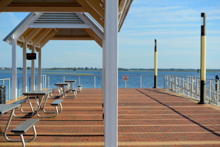 Boardwalk pier with picnic tables and benches under pavilions in the Kissimmee lakefront park with Lake Toho in the background. File photo: Liz Stors, Shutterstock.com, licensed.